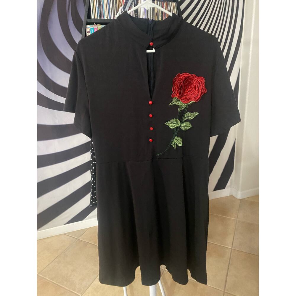 Black dress with embroidered rose.